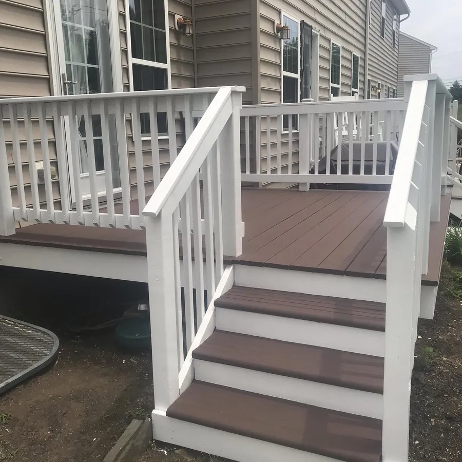 Backyard deck after cleaning and refinishing, fresh brown stain on boards and steps